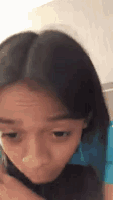 a close up of a young girl 's face with a nose ring .