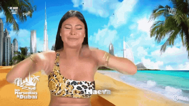 a woman in a bikini is on a beach with the word dubai on the bottom right
