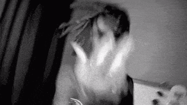 a black and white photo of a person 's face with a hand reaching out .