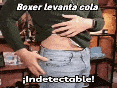 a man in a green sweater and blue jeans is holding his stomach with a caption that says boxer levanta cola indetectable