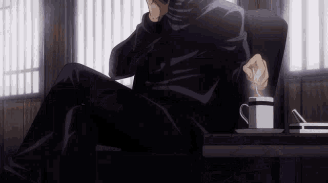 a man is sitting in a chair with a cup of coffee and a spoon in his hand .