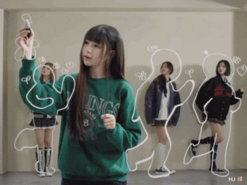 a girl wearing a green sweatshirt with the word kings on it