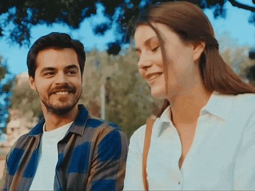 a man and a woman looking at each other and smiling