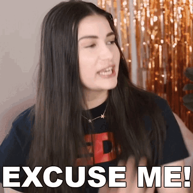 a woman says excuse me while wearing a black t-shirt
