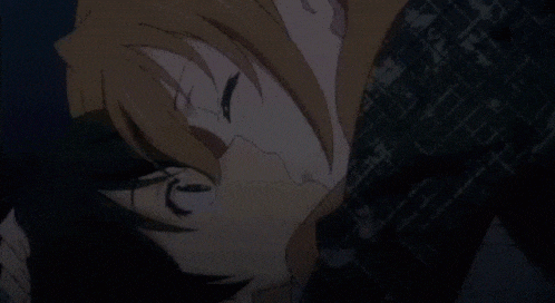 a man and a woman are kissing in a dark room in an anime .