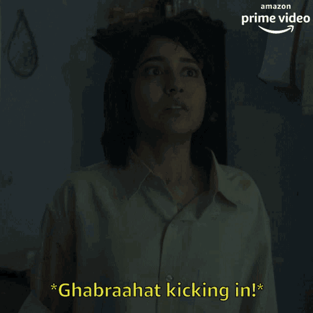 a woman is standing in front of a sign that says ' ghrabaahat kicking in '