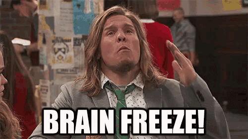 a man in a suit and tie is giving the middle finger and says brain freeze !