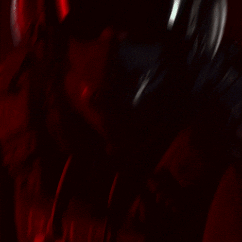 a blurred image of a person 's face with a red background