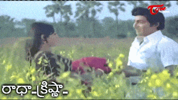 a man and a woman are standing in a field of yellow flowers with a watermark that says ' time '