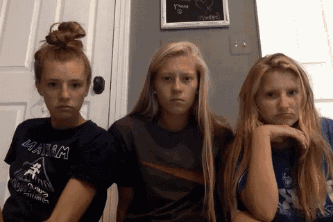 three girls are sitting next to each other with one wearing a shirt that says ' 4aam ' on it