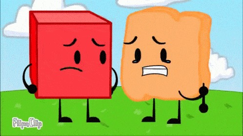 a red block and an orange block are standing next to each other in a grassy field .