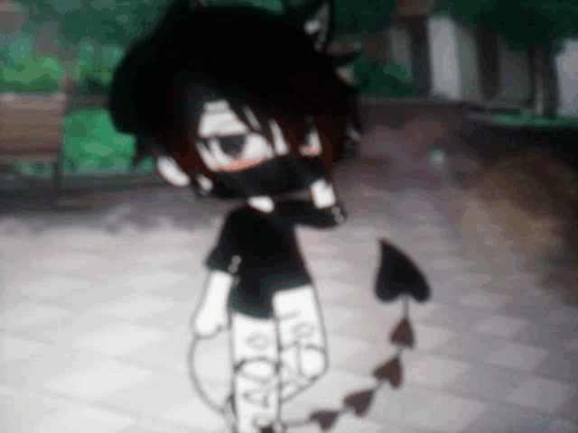 a boy with a mask on his face is standing on a sidewalk in a park .