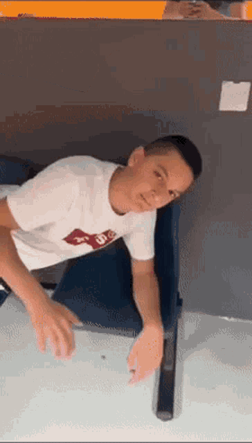 a young man wearing a white shirt that says levis on it