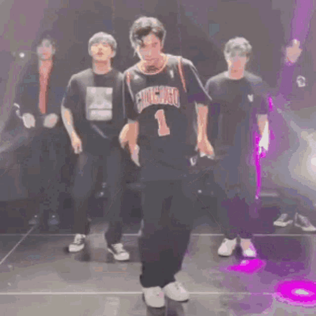 a man wearing a chicago jersey is dancing on a stage .
