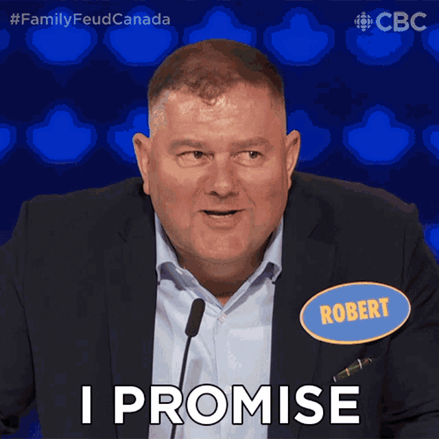 a man in a suit and name tag that says robert says i promise
