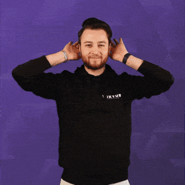 a man wearing a black hoodie that says voxtur
