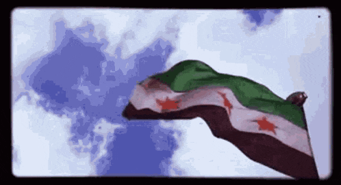the syrian flag is waving in the wind