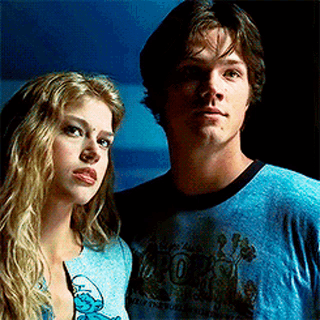 a man and a woman are standing next to each other and the man is wearing a shirt that says rock