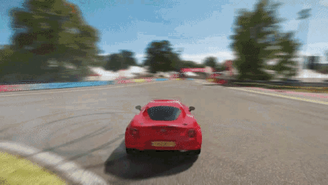 a red sports car is driving down a road with a license plate that says ' sgc ' on it