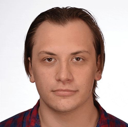 a man in a plaid shirt looks at the camera with his eyes closed