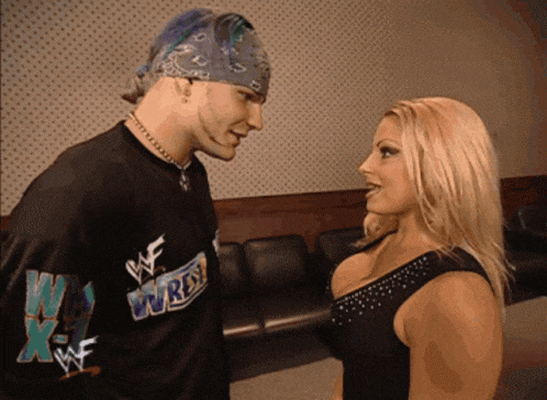 a man and a woman are looking at each other and the man is wearing a shirt that says we wrestle