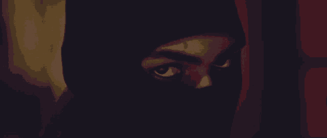 a close up of a person 's face with a black mask on