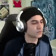 a man wearing headphones is sitting in a chair .