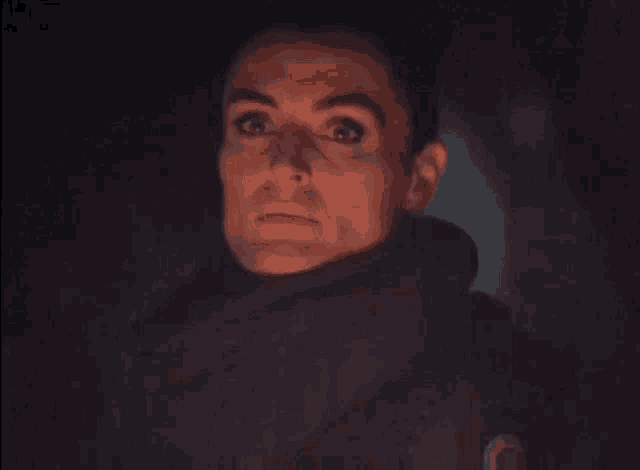a close up of a person 's face in the dark