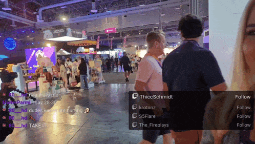 a group of people standing in a room with a follow button on the bottom right