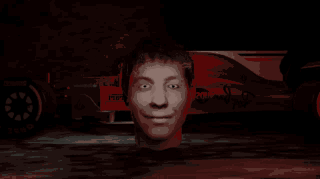 a man 's head is visible in front of a red ferrari car