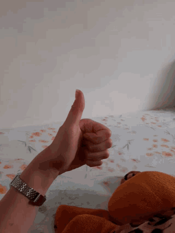 a person with a watch on their wrist is pointing at something