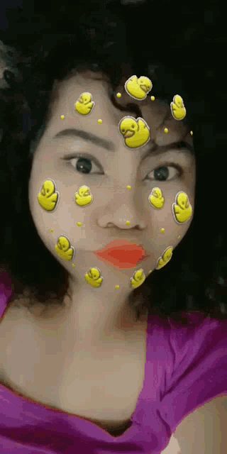 a woman with rubber ducks on her face looks at the camera