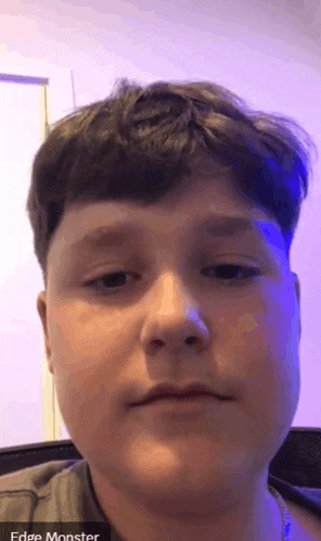a close up of a young boy 's face with the words edge monster visible in the corner .