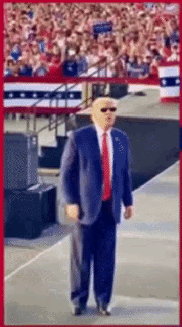 a man in a suit and tie is standing on a stage