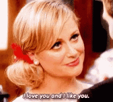 a woman is smiling and saying `` i love you and i like you . ''