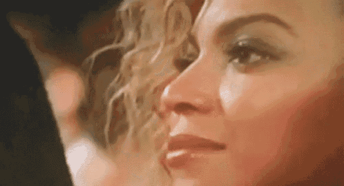 a close up of a woman 's face with her eyes closed and her hair visible .