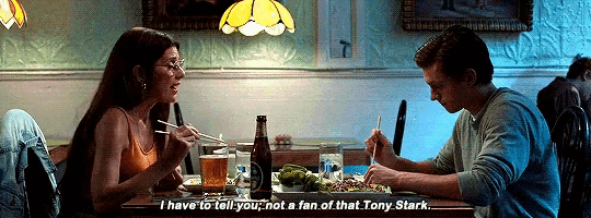 a man and a woman are sitting at a table in a restaurant and the woman says i have to tell you not a fan