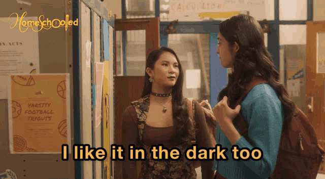 two girls talking in a hallway with the words i like it in the dark too on the bottom