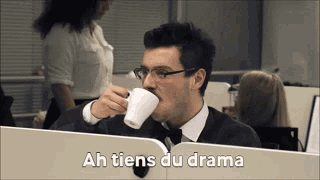 a man drinking a cup of coffee with ah tiens du drama written on the bottom