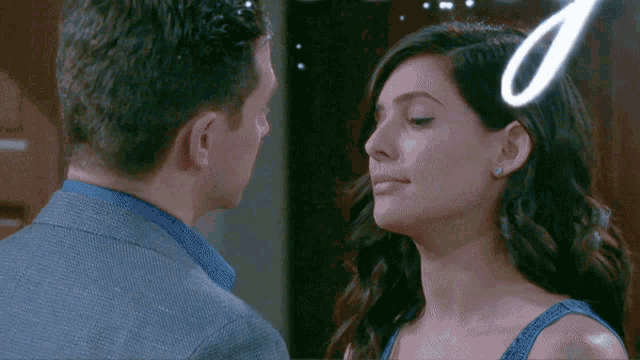 a man and a woman are looking into each other 's eyes with a number 0 behind them