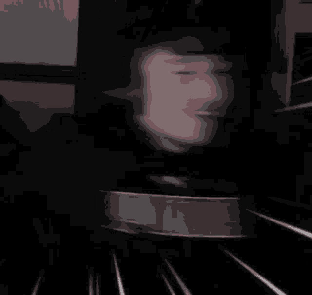 a blurry picture of a person 's face with white lines coming out of it 's eyes .