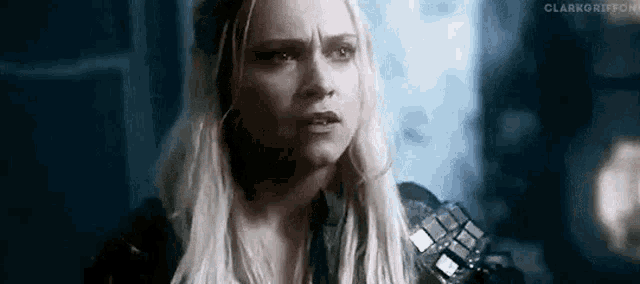 a close up of a woman 's face with a serious expression .