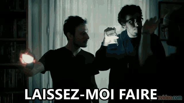 a man holding a light next to another man with the words laissez-moi faire