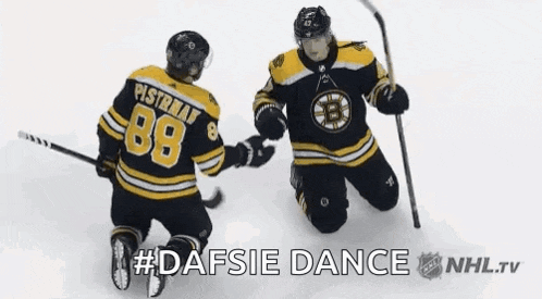 two hockey players are kneeling on the ice and one of them has the number 88 on his jersey