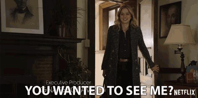 a woman is standing in front of a door with the words " you wanted to see me " on the bottom