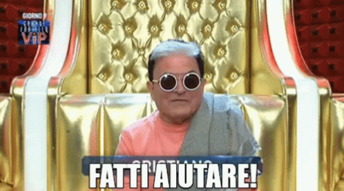 a man wearing sunglasses is sitting in a chair that says fatti ' aiutare ' on it