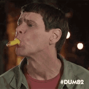 a man in a green jacket is eating a piece of food with his tongue .