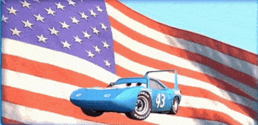 a blue car with the number 43 on the side is driving in front of an american flag