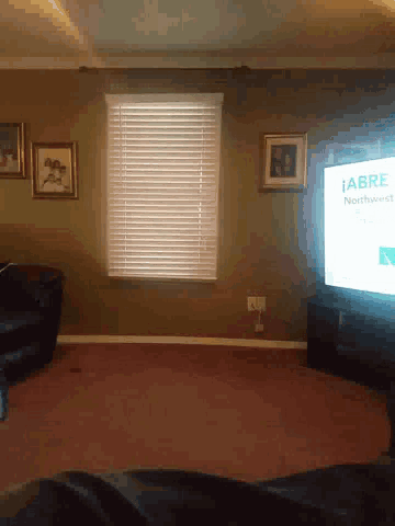 a living room with a flat screen tv that says " abre northwest "