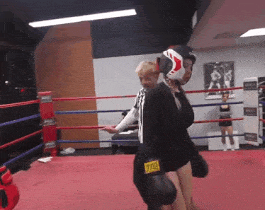 a person wearing everlast boxing gloves in a ring